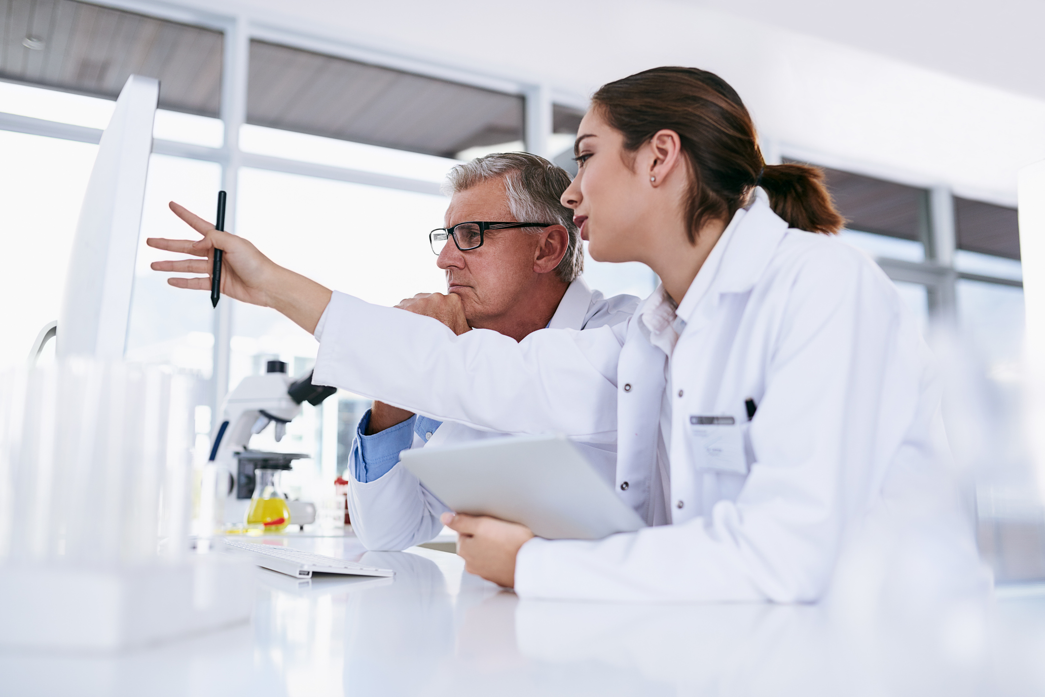 Shot of two scientists working together on a computer in a lab
